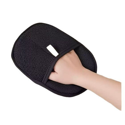 Black pet hair remover mitt on a hand